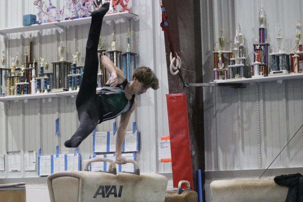 Gymnast Performing a Scissor on Pommel Horse